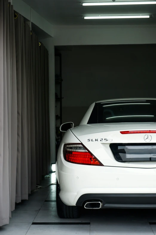 a white car is parked in a garage