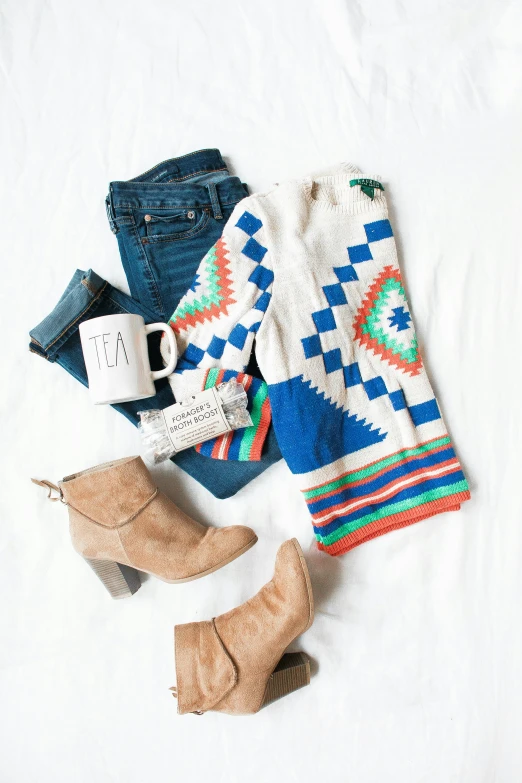 knitted sweaters and boots with sweater, mug and blanket