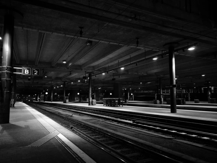 a train station with train tracks and lights