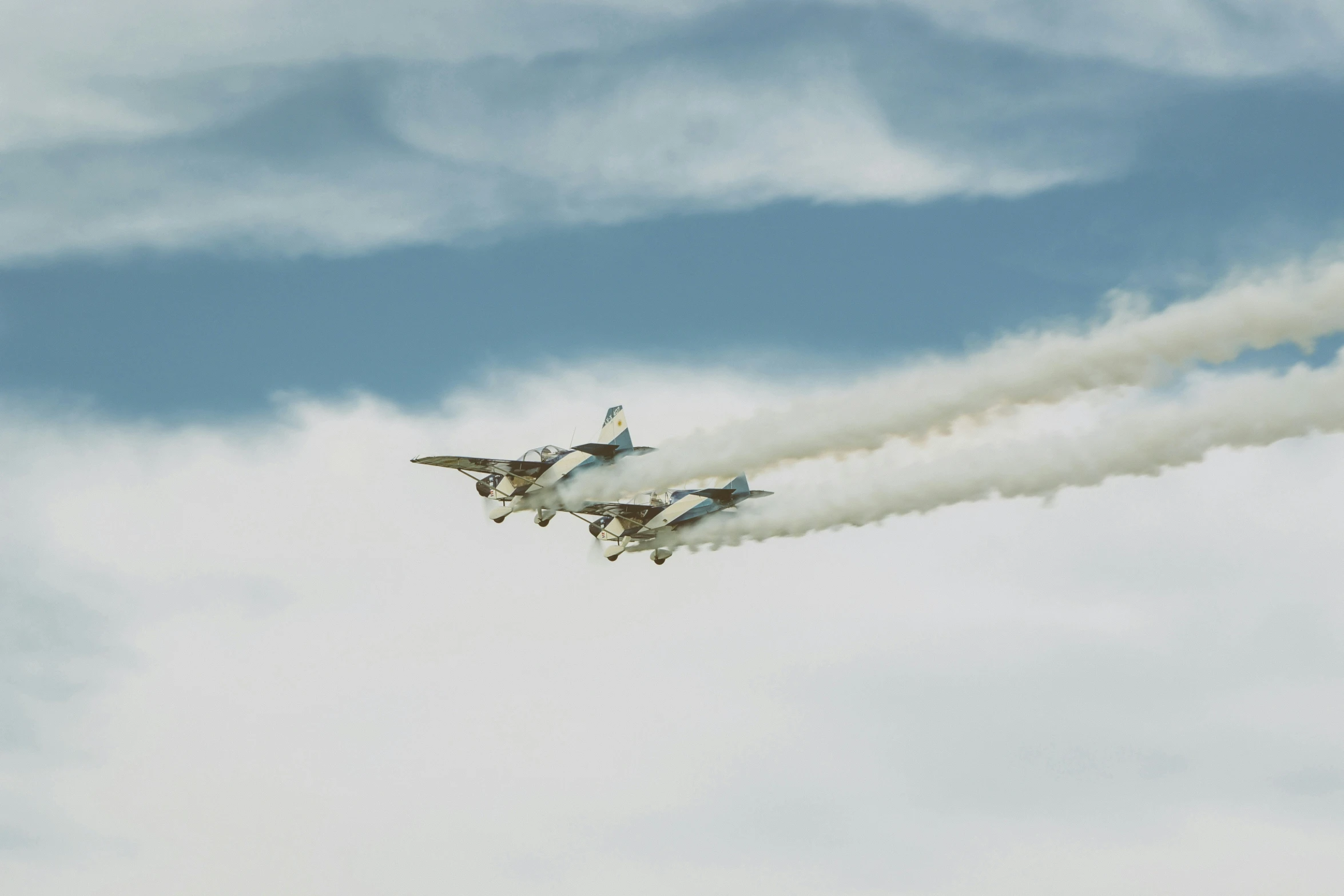 two jets flying side by side in the sky