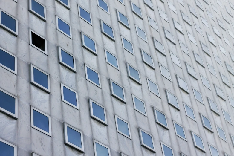 a large gray building has small windows