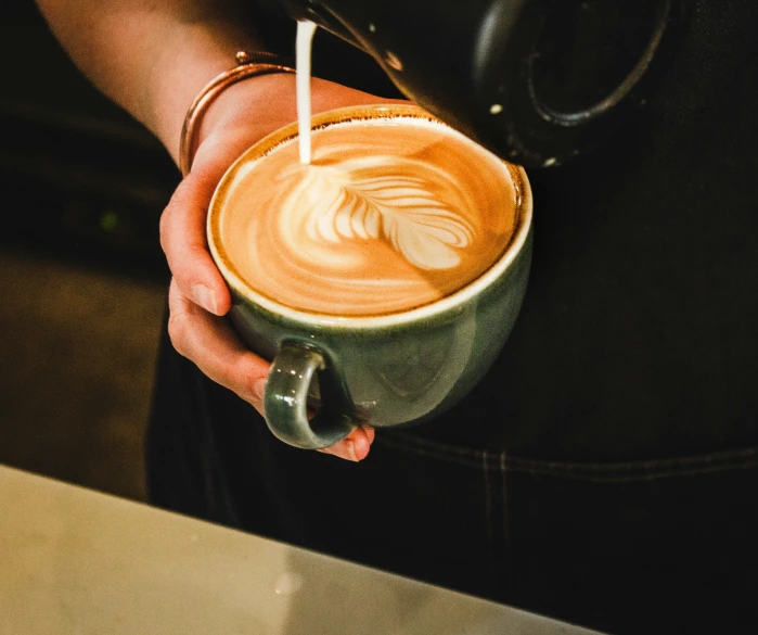 a person holding a coffee in their hand