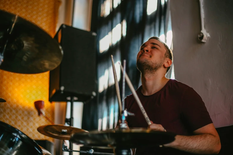 man playing drums in front of the music stage