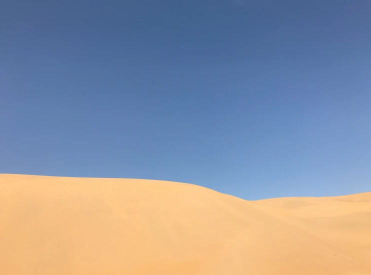 a desert with a blue sky and sand
