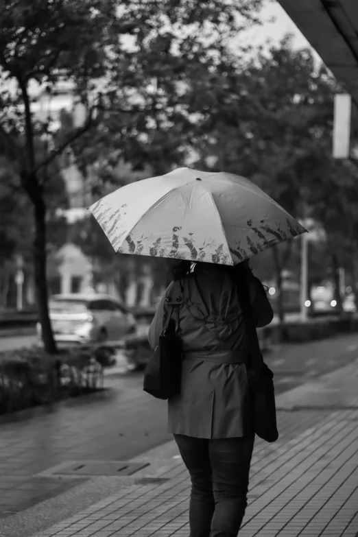 a black and white po of a woman holding an umbrella