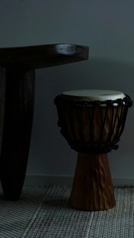 a drum sitting next to a large table