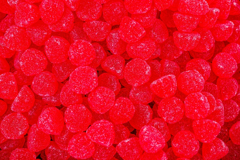 the texture of red gummy heart pieces in color