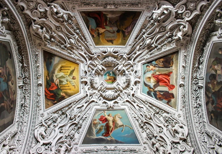 a ceiling with paintings in an old building