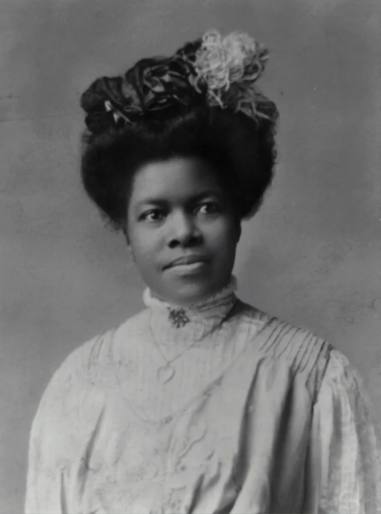 black and white portrait of a woman with curly hair in an african american po