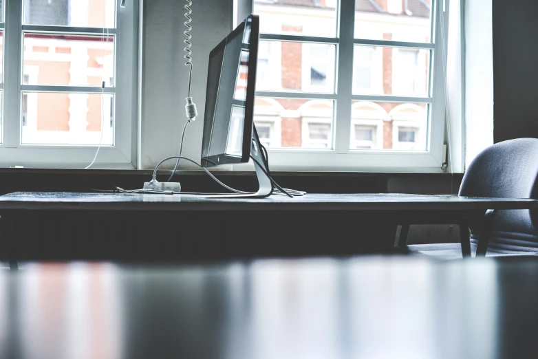 the desk has a chair and computer monitor on it