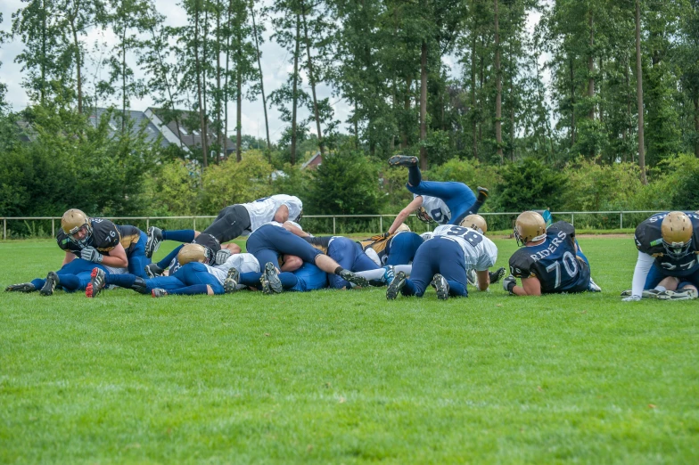 a group of people on a field that are wearing blue and white uniforms