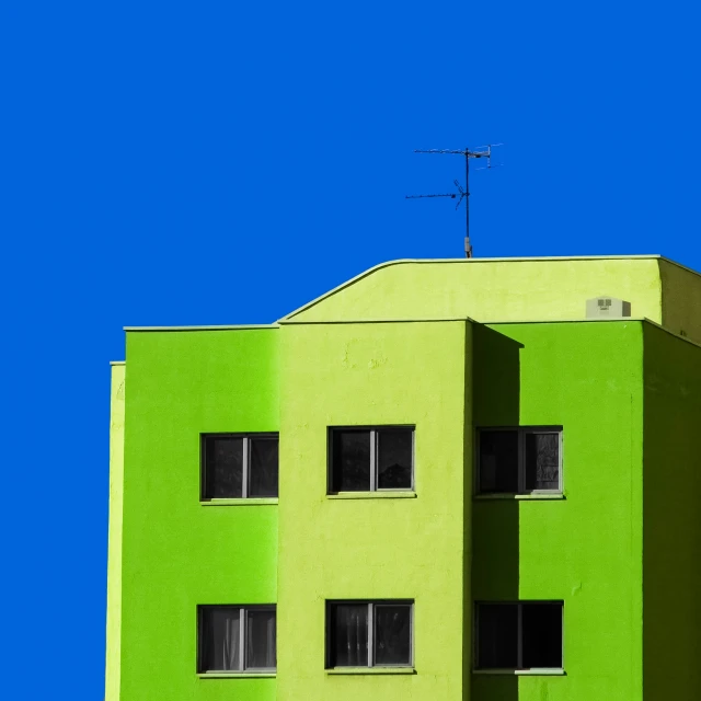 a large bright green building with lots of windows