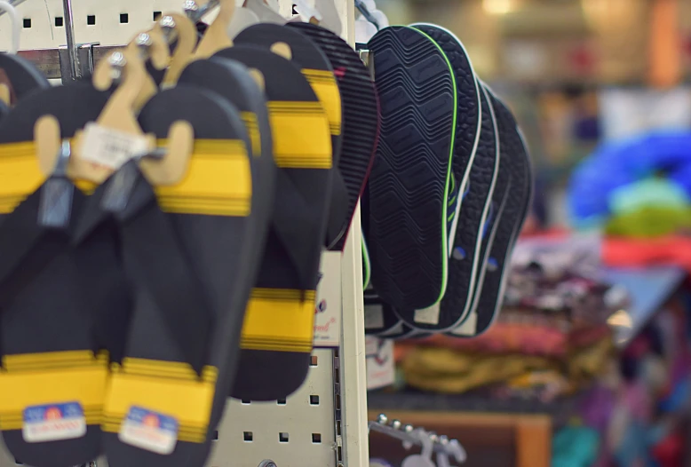 pairs of shoes hanging up from racks in a store