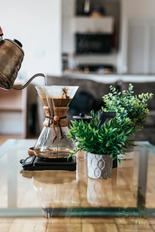 a person pours coffee into a glass topped table