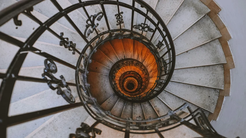 a closeup s of the top spiral staircase of an old building