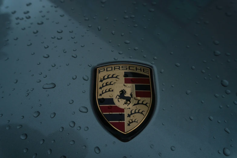 there is a black porsche emblem on a blue background