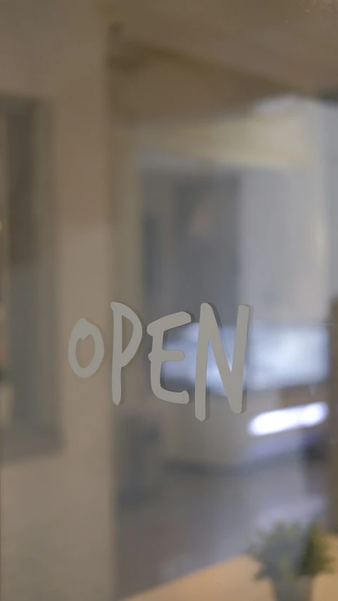 the open sign is on the glass door