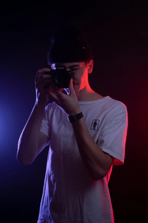 a man holding up a camera in his hands