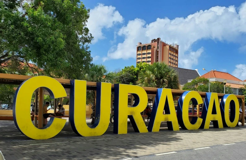 the letters curacao are on display in front of a crowd