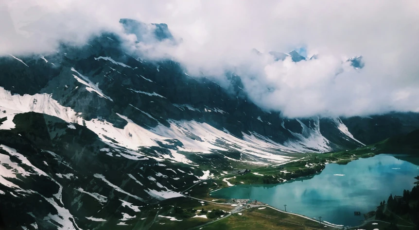 there is a view of mountains and lakes in the snow