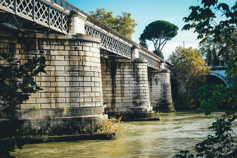 a stone bridge crossing a body of water