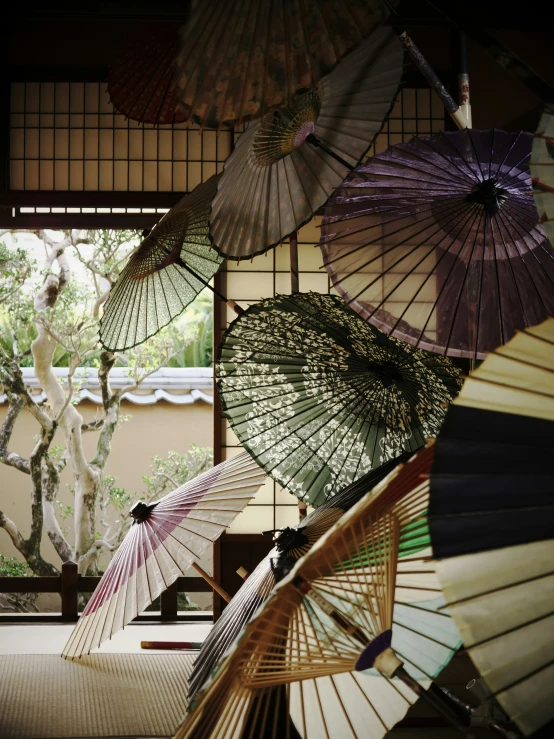 asian style umbrellas of various colors inside an open room