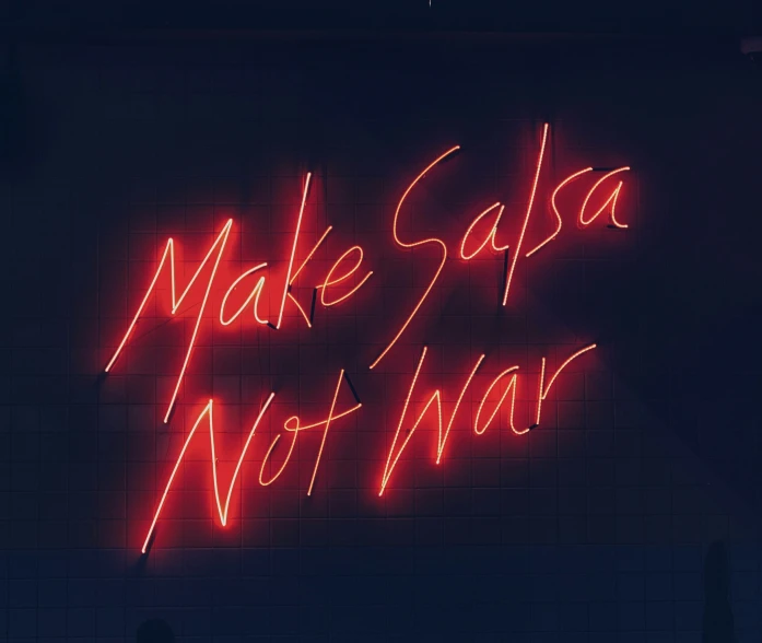 a neon sign saying make sata not war