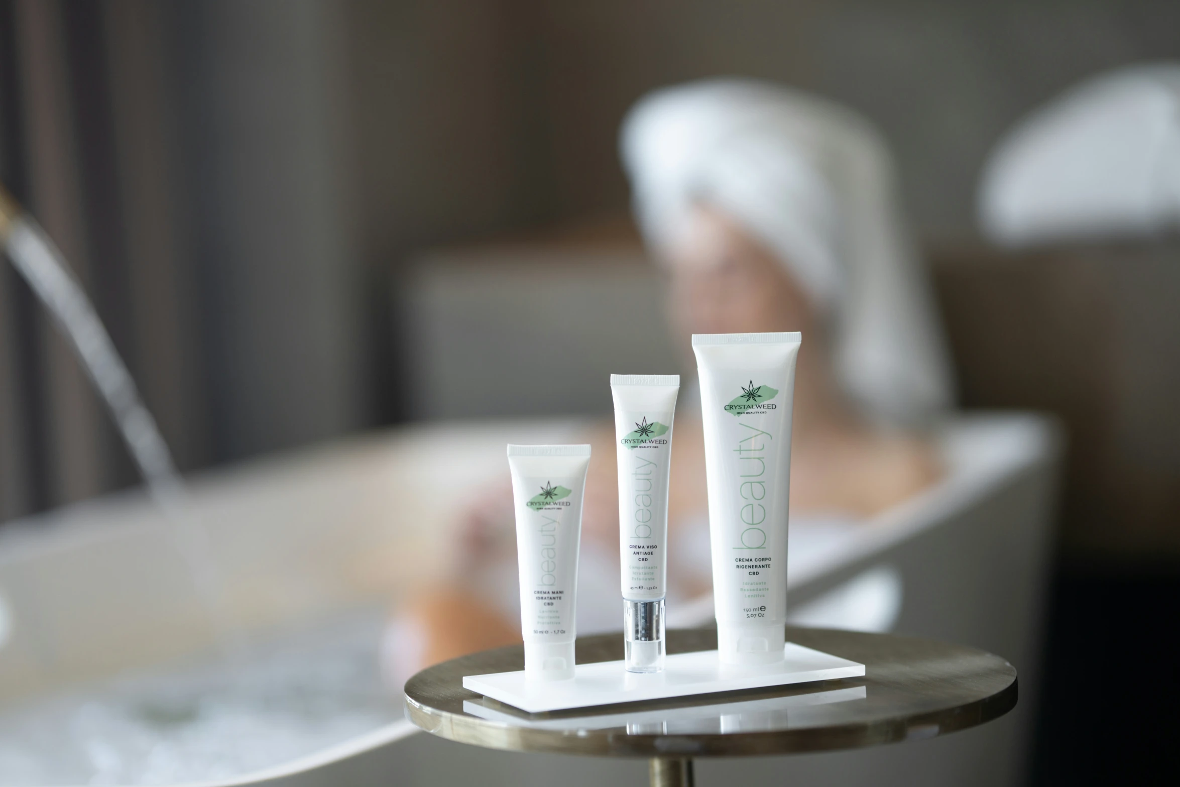 a couple of tubes of cream on a tray next to a bathtub