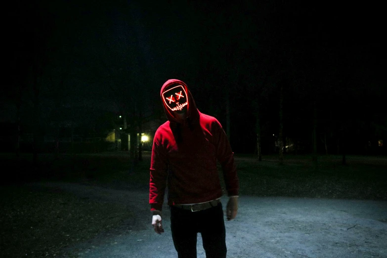 a man is in a red sweatshirt with a scary face