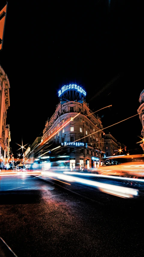 cars are driving down a busy city street