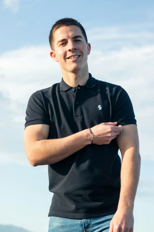 a man standing with his hands folded up