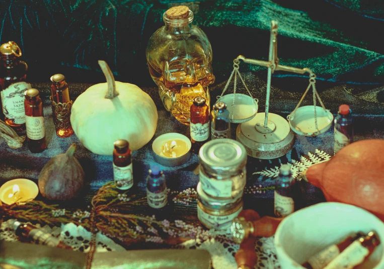 a number of objects such as candles, jars and a weight scale