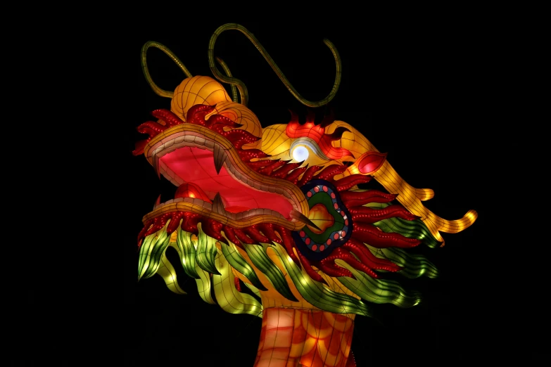 an intricate dragon lantern is lit up at night