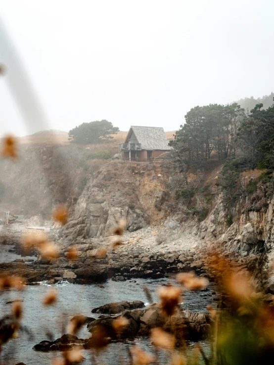 a house perched on a cliff by the ocean