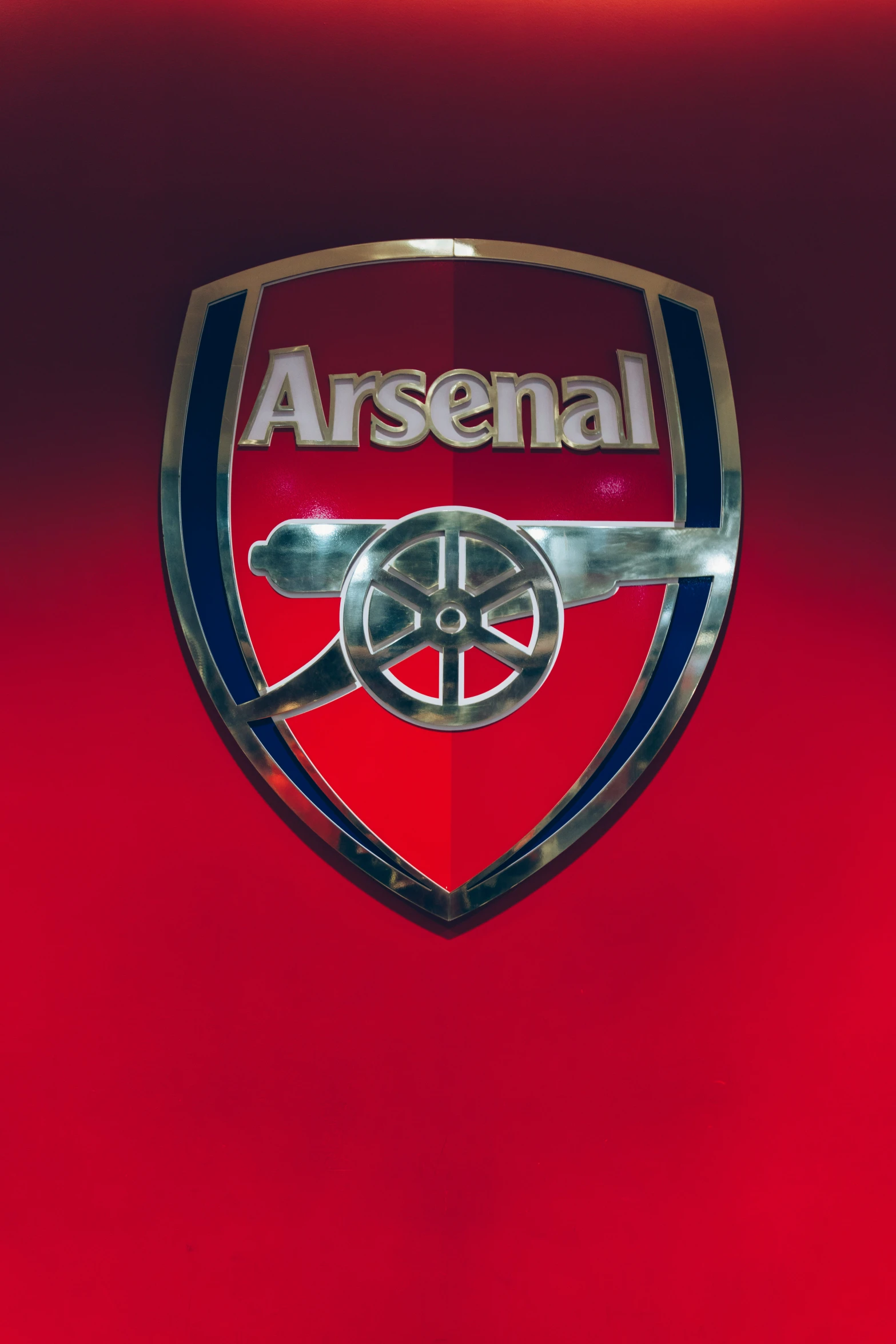 an emblem with a background of red, black and blue