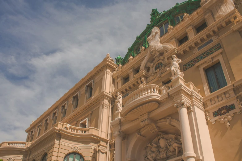 ornate stone building with a horse and scroll work on the top