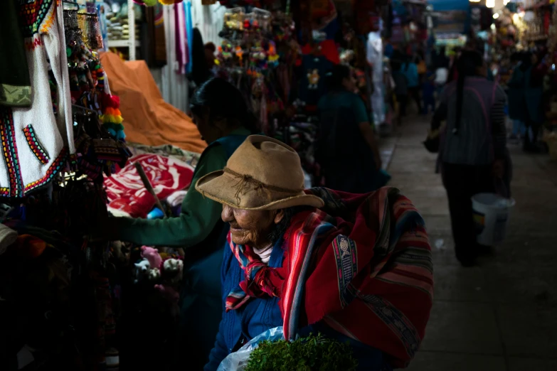 an older man with hat looking at things