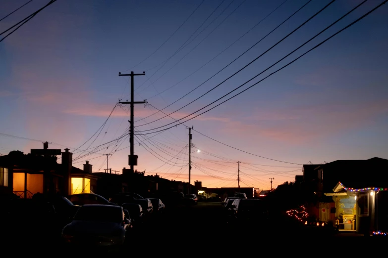 cars are parked in the parking lot by power lines