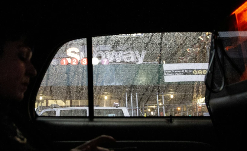 car window covered in snow at night