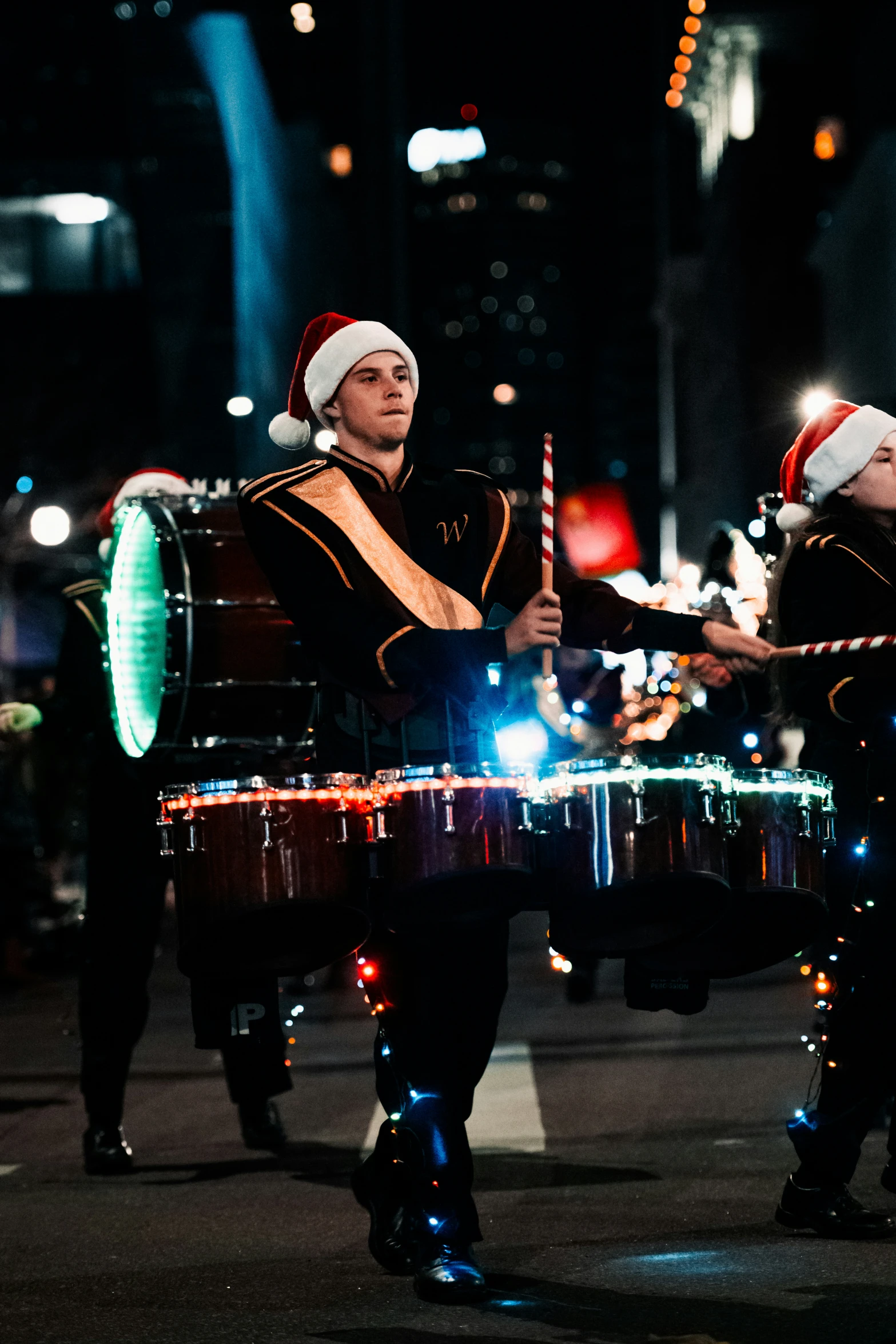 a band with a man on top of a drum