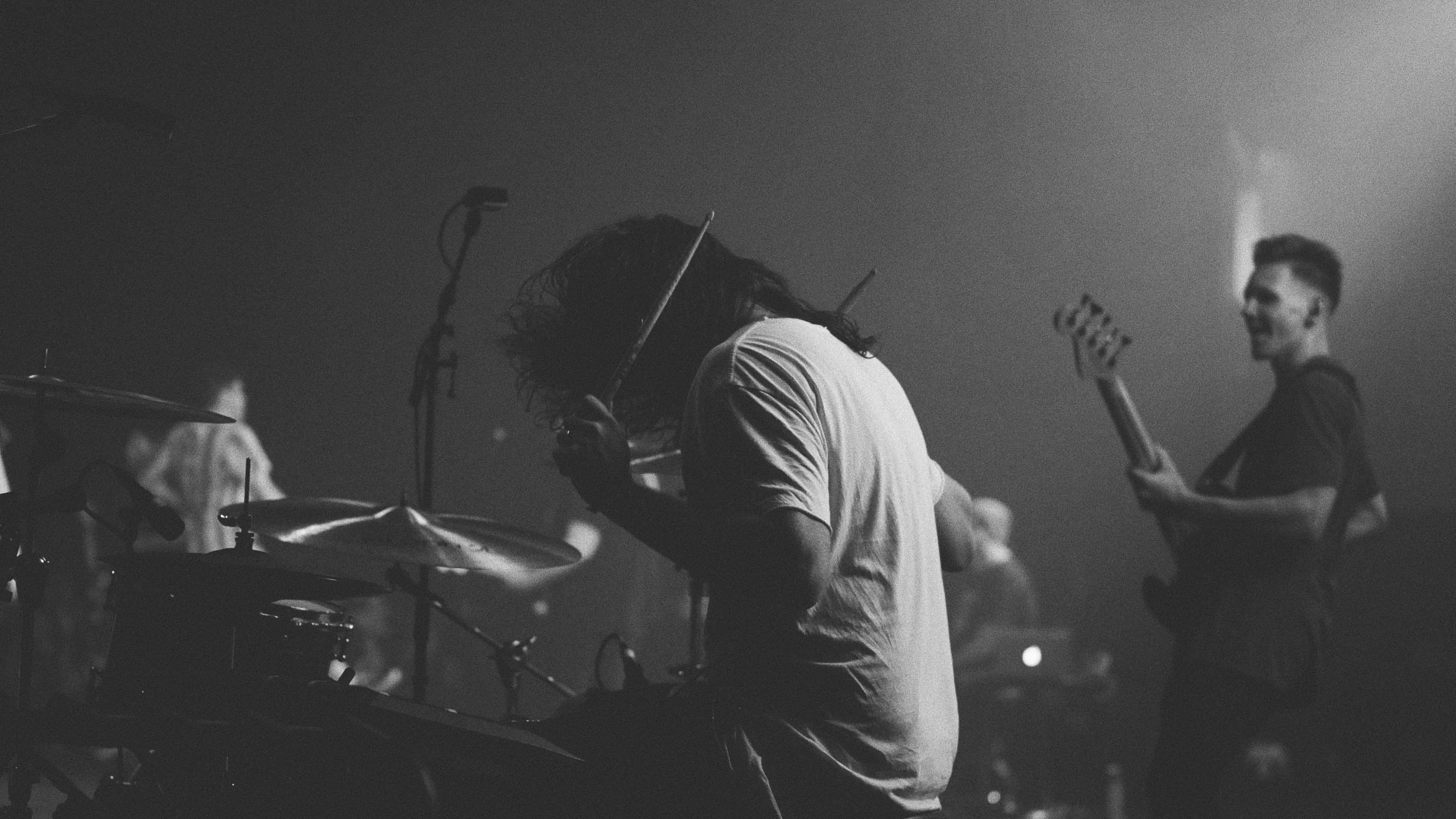 two musicians are playing music on stage at night