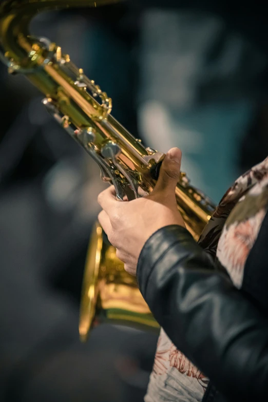 a man playing a trombone with the wind and music