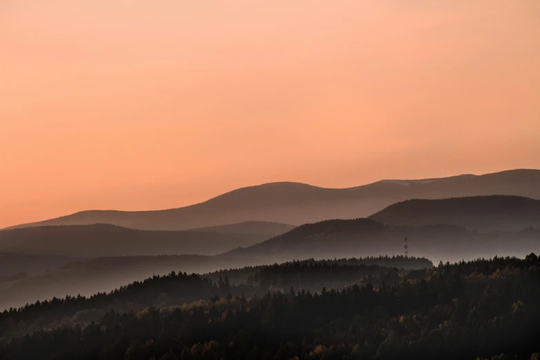 a mountain range and a hazy sky during sunset