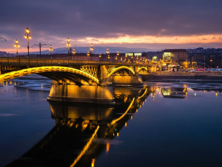 a bridge with a reflection on the water