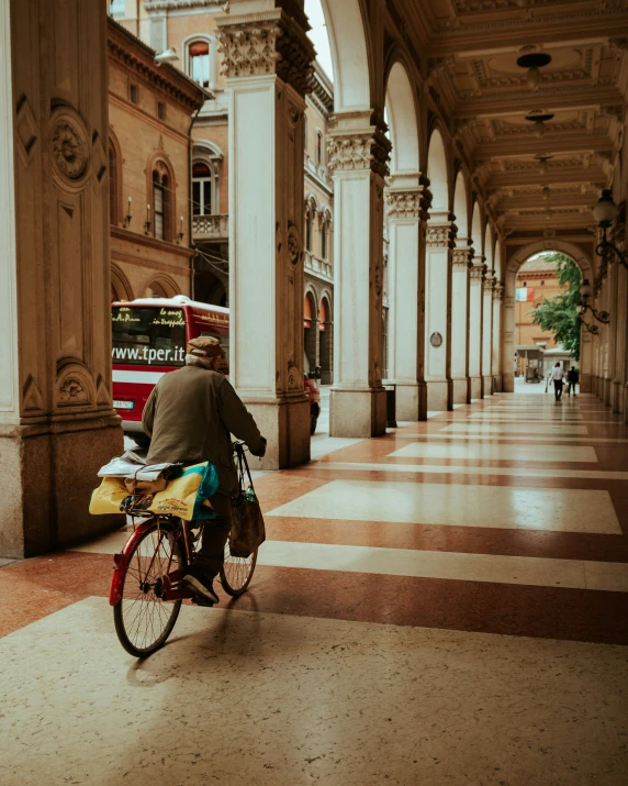 a man on a bike passing by another vehicle