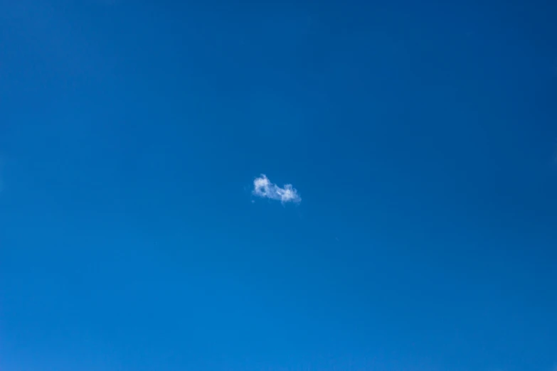 a kite in the sky with another airplane flying in the background