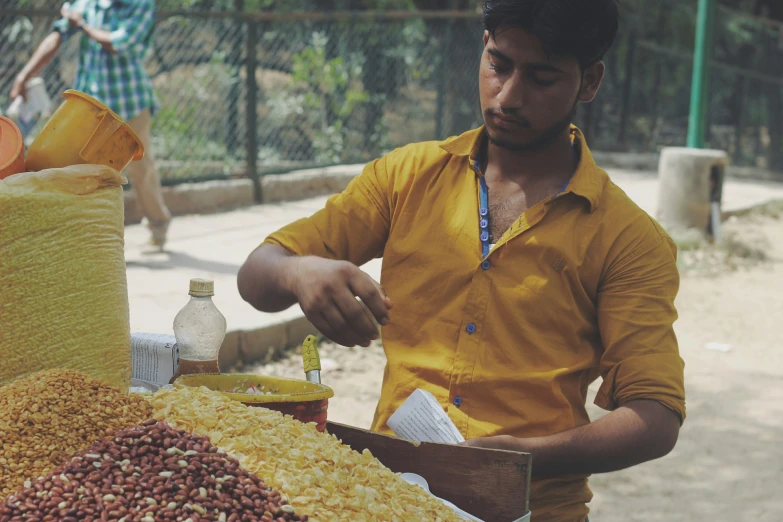 a man is cooking some food at an outdoor market