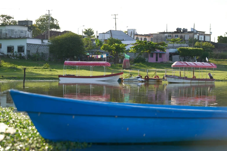 three small boats floating on top of a lake