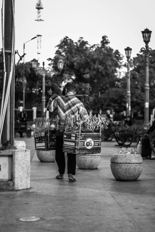 black and white pograph of people carrying large baskets