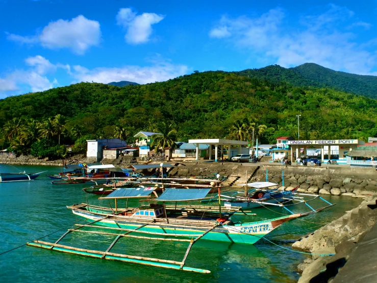 there are many small boats docked at the harbor